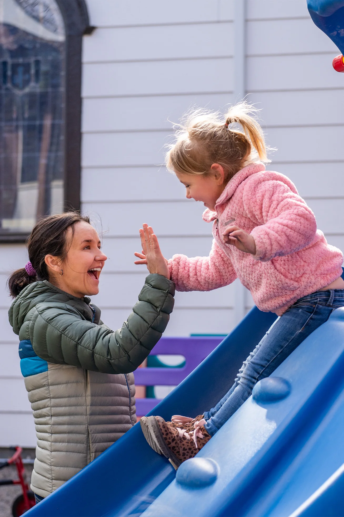 An educator at the Choteau Youth Alliance gives a child a high five