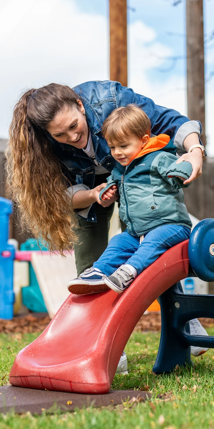 Amy Paden, plAyBCs owner, plays with a child outside of her childcare facility