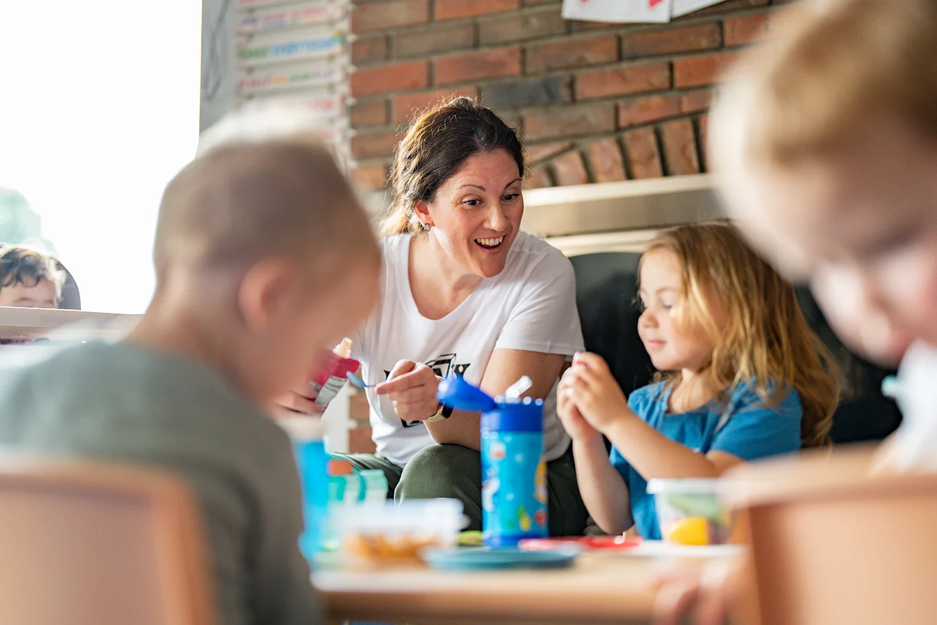 Amy Paden, plAyBCs owner engages with children during lunchtime