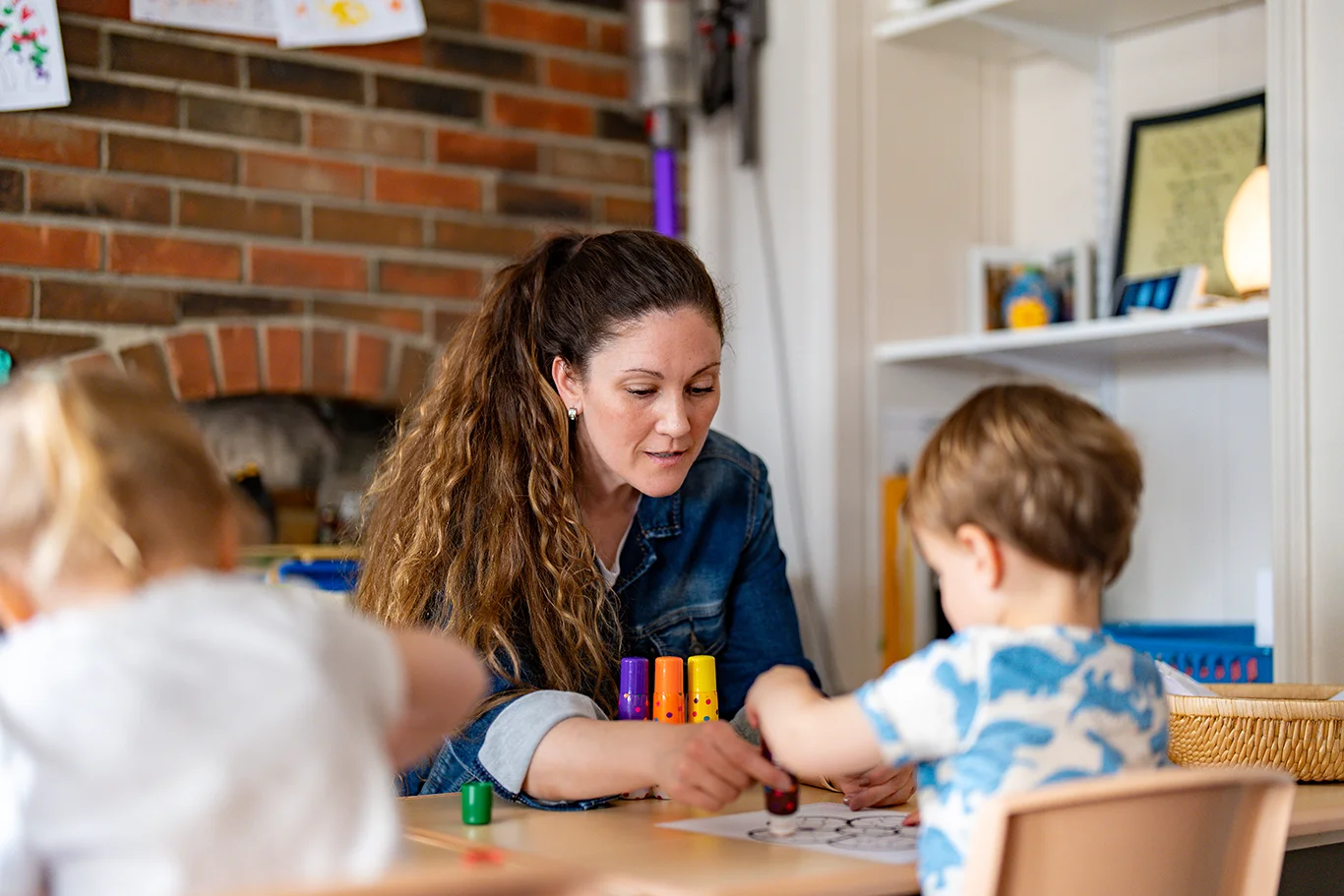 Amy Paden, plAyBCs owner engages with a child during craft time